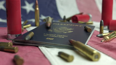 Caliber-Bullets,-Shotgun-Shells,-And-American-Passport-On-Patriotic-American-Flag