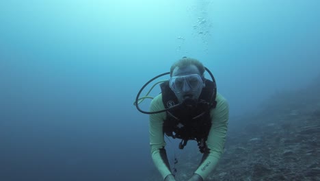 A-diver-takes-a-selfie-against-deep-blue-water