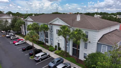 Modern-apartment-complex-with-parking-lot-and-cars