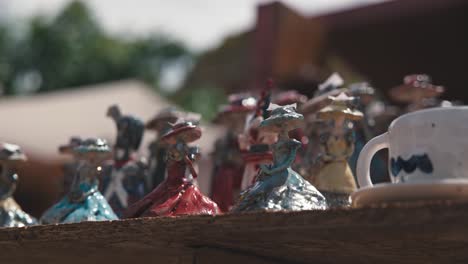 Close-up-of-handcrafted-figurines-and-a-mug-at-Varaždin's-Market-of-Traditional-Crafts