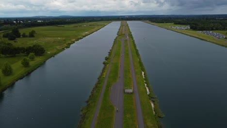 Drone-shot-of-Triathlon-at-Dorney-lake,-triathletes-cycling-and-competing-on-the-track