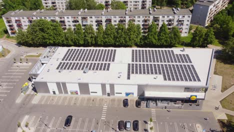 Iconic-LIDL-supermarket-on-sunny-day-in-Ryga-suburbs,-aerial-orbit-view