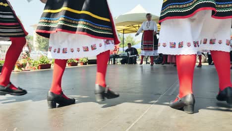 Bulgarian-folk-dance-group-finish-stage-performance-with-leg-stomp