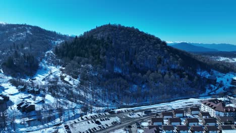 Ein-Weitläufiger-Blick-Auf-Eine-Schneebedeckte-Berglandschaft-Mit-Gipfeln,-Tälern-Und-Dichten-Wäldern,-Der-Die-Unberührte-Schönheit-Einer-Winterumgebung-Zeigt