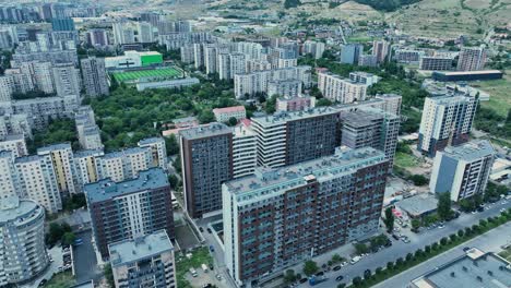 An-aerial-view-of-a-city-with-high-rise-buildings-dominating-the-skyline,-showcasing-the-density-and-architecture-of-urban-living