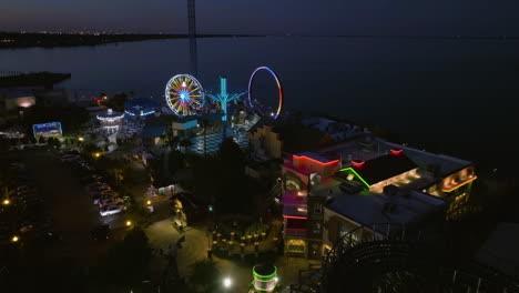 Establishing-drone-shot-of-the-Kemah-Boardwalk-park,-evening-in-Texas,-USA