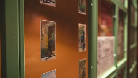 Close-up-of-vintage-chocolate-themed-postcards-displayed-in-a-green-framed-case-at-Zagreb's-Chocolate-Museum