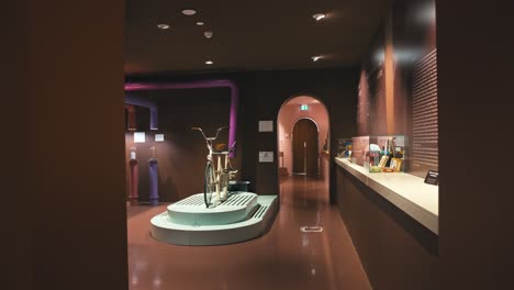 Interior-view-of-Zagreb's-Chocolate-Museum-featuring-an-interactive-bicycle-exhibit-and-display-cases