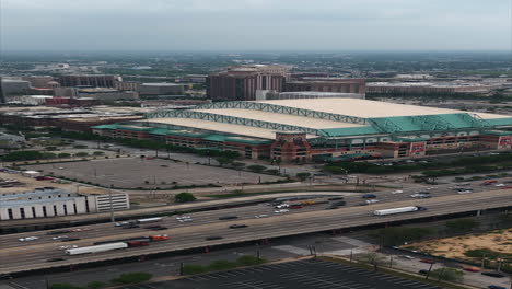 Portrait-drone-shot-circling-the-Minute-maid-park,-in-sunny-Houston,-USA