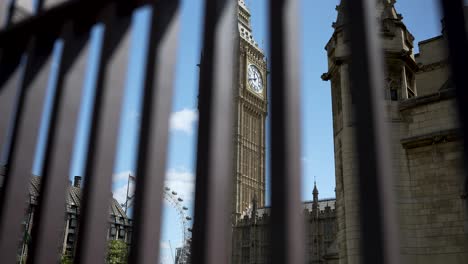 Slow-motion-footage-captures-a-sweeping-view-of-Big-Ben-in-London,-England,-through-the-bars-of-an-iron-fence