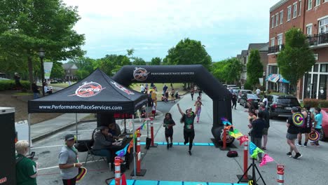 Happy-Kids-and-Adult-runner-finishing-run-in-american-town