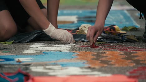 Close-up-of-hands-creating-intricate-sidewalk-chalk-art-during-Zagreb's-Cest-is-d'Best-street-festival