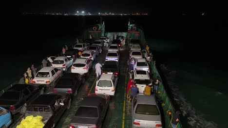 Landing-craft-commercial-boat-carrying-vehicles-night-float-green-water-port-UAE-maritime-transport-shipping-United-Arab-Emirates-vehicle-transfer-waterways-sea-vibrant-activities-dock-cargo-ship-iran