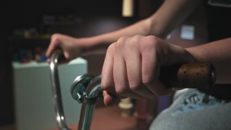 Close-up-of-hands-gripping-bicycle-handlebars-in-an-interactive-exhibit-at-Chocolate-Museum