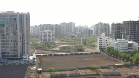 Drone-camera-moving-upwards-where-a-construction-site-is-about-to-start-inside-a-farm