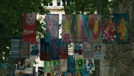 Colorful-art-banners-hanging-between-trees-at-Zagreb's-Cest-is-d'Best-street-festival