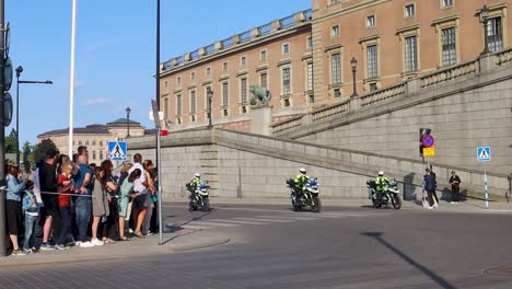 Police-on-motorcycles-by-Stockholm-Palace-on-Sweden’s-National-Day,-static-slomo