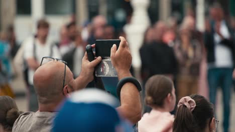 Person-capturing-a-video-on-a-smartphone-during-Zagreb's-Cest-is-d'Best-street-festival