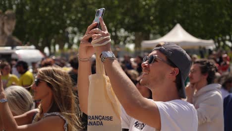 slow-motion-shot-of-people-filming-the-Olympic-torch-relay-at-the-Arc-de-Triomphe