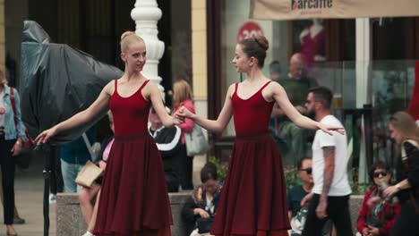 Two-ballet-dancers-in-red-dresses-performing-at-the-Cest-is-d'Best-street-festival-in-Zagreb,-Croatia