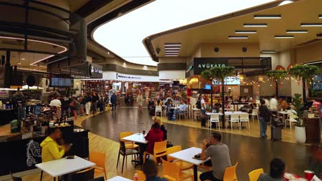 Timelapse-of-eating,-drinking,-passing-and-shopping-people-waiting-for-departure-at-San-Jose-Juan-Santamaria-Airport-restaurant-area-in-Costa-Rica