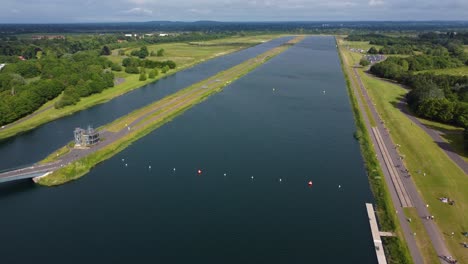 Drone-shot-of-Triathlon-at-Dorney-lake,-triathletes-cycling-and-competing-on-the-track