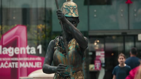 Street-performer-in-metallic-costume-and-makeup-posing-as-a-statue-at-Zagreb's-Cest-is-d'Best-street-festival