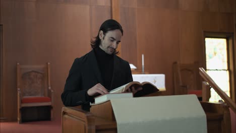 Christian-pastor,-preacher,-priest-in-old-church-reading-and-studying-a-bible-at-church-pulpit