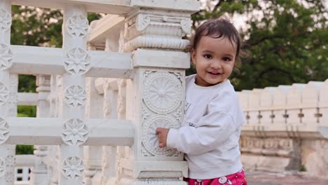 cute-toddler-innocent-expression-at-temple-courtyard-at-day-from-unique-perspective