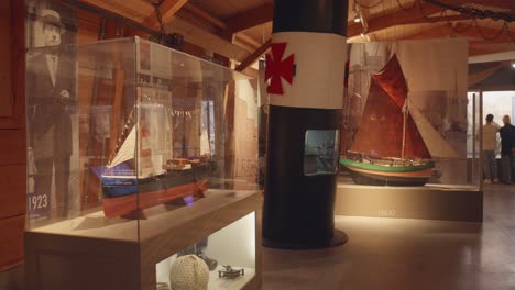 Historic-maritime-museum-exhibit-in-La-Rochelle,-France-showcasing-model-ships-and-nautical-artifacts