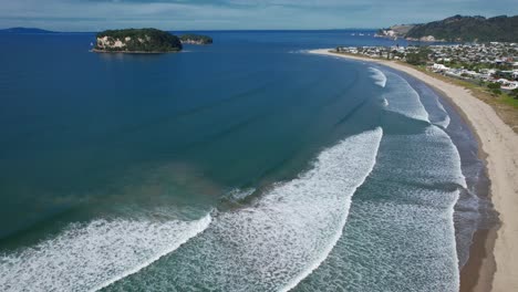 Foamy-Ocean-Waves-Splashing-At-Whangamata-Beach-In-New-Zealand---Aerial-Shot