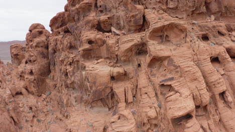 Aerial-revealing-shot-of-valley-of-fire-behind-the-textured-Red-Sandstones-in-Nevada