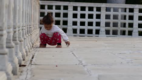 cute-toddler-walking-at-temple-courtyard-at-day-from-unique-perspective