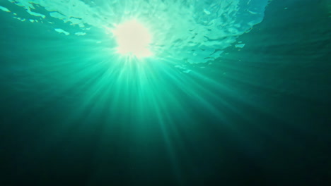 Sunlight-Piercing-Through-Ocean-Water,-view-from-diver