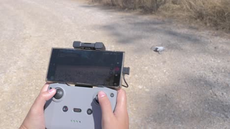 Close-up-shot-of-hands-taking-off-a-drone-with-a-remote-control