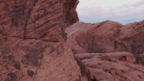 Cinematic-fly-through-aerial-shot-of-Red-Sandstone-valley-in-Nevada