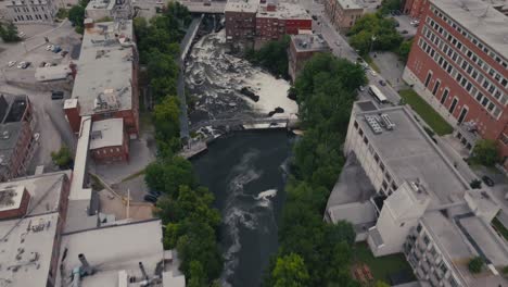 Aerial-View-Of-Buildings-Along-Magog-River-Gorge-In-Sherbrooke-City,-Quebec-Canada