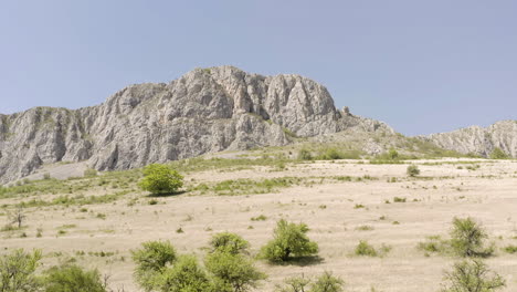 Slow,-rising-view-of-Piatra-Secuiului,-Romania,-a-barren,-limestone-mountain-peak-near-villages-of-Rimetea-and-Coltesti