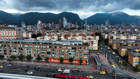 Aerial-view-over-traffic-and-apartments-in-Bogota-city,-in-cloudy-day-in-Colombia