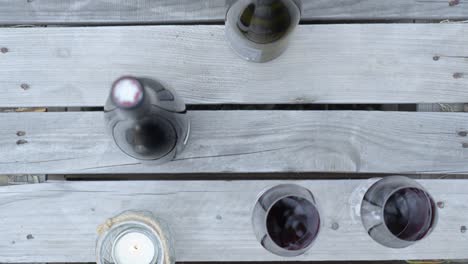 to-down-shot-overhead-wine-bottles-and-glasses-on-display-on-a-table