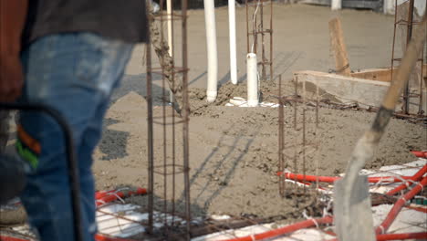 Slow-motion-close-up-shot-of-fresh-concrete-mix-being-poured-at-a-construction-site-in-Mexico-to-make-the-bald-of-a-house