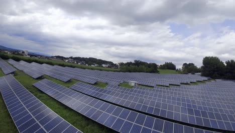 Drone-flying-above-the-solar-panels-installed-on-the-fields,-agricultural-photovoltaic-system,-Styria,-Austria