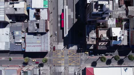 Top-Down-Aerial-View-of-Downtown-Bogota-Street-Traffic,-Buildings,-Intersection-and-Bus-Station