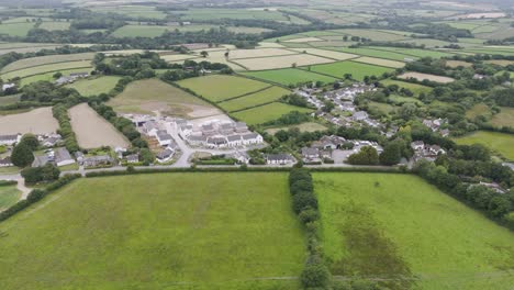 Aerial-view-of-new-build-development-in-Folly-Gate,-Okehampton-UK,-showing-construction-and-surrounding-fields