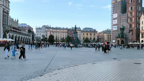 Panoramic-view-of-crowd-of-tourists-at-Main-Square-of-Old-Town-of-Krakow-in-the-evening,-renaissance-buildings-and-picturesque-streets-of-Poland