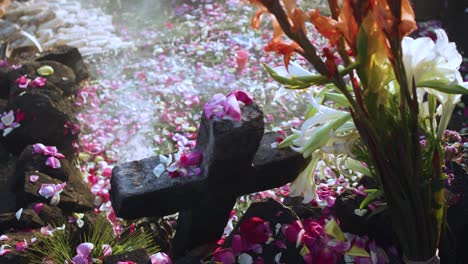 Authentic-Mayan-ceremony-with-traditional-floral-offerings-and-incense-smoke-swirling-around-a-cross