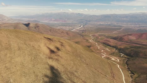 Bird's-eye-view-of-the-road-leading-to-the-Serranias-El-Hornocal-in-Humahuaca,-Argentina