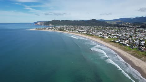 Playa-De-Whangamata-Y-Paisaje-Urbano-En-Coromandel,-Nueva-Zelanda---Toma-Aérea-Con-Drones