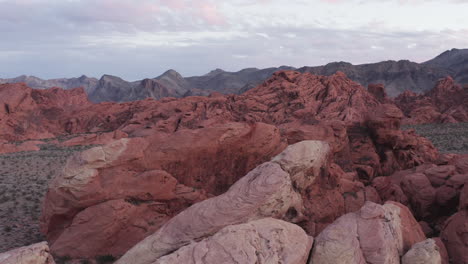 Cinematic-pull-back-aerial-shot-of-Nevada's-red-sandstones-with-copy-space