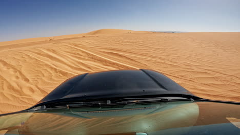 Driving-over-the-vast-sandy-dunes-of-Erg-Chebbi-in-Merzouga-during-a-sunny-day-in-the-Sahara